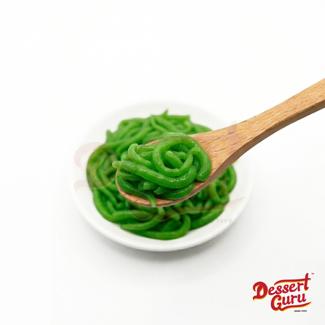 Close-up of Dessert Guru premium ready-to-eat green pandan chendol strands on a wooden spoon.
